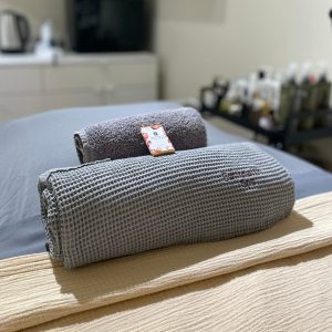 Rolled towels on spa bed to welcome client